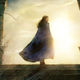 Rosamund Pike's Moiraine Damodred looks away from the glare of the sun.